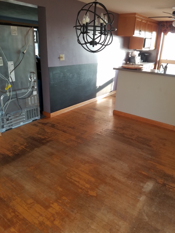 A kitchen floor before replacement by our hardwood flooring contractors