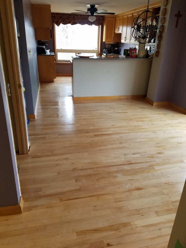 Our flooring contractors can refinish distressed hardwood like this Wisconsin kitchen
