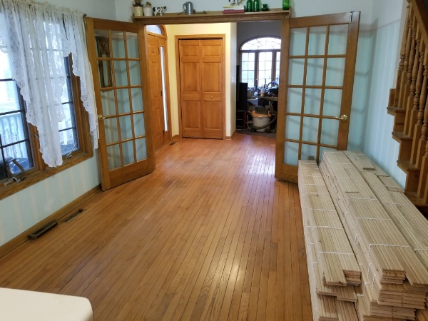 Flooring Contractors begin a custom hardwood dining room floor installation
