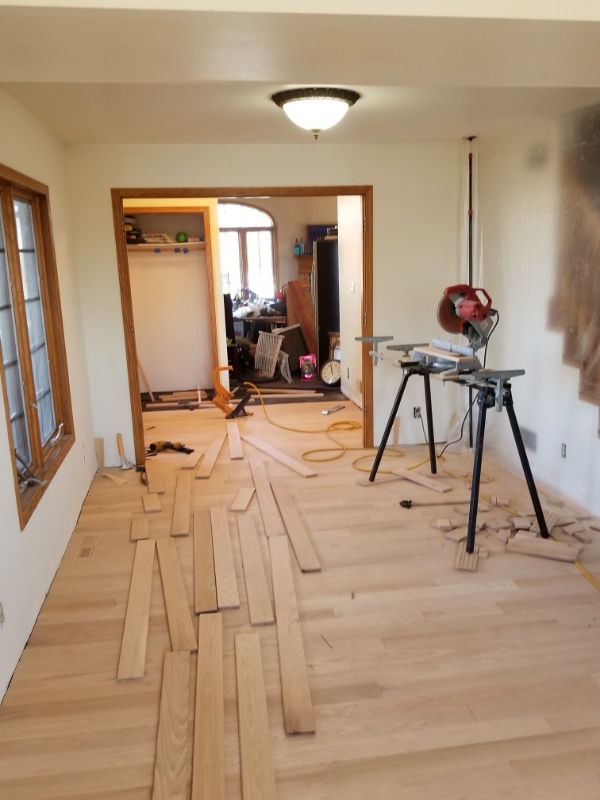 Hardwood Installation Contractors Work to Finish a Living Room in Wisconsin