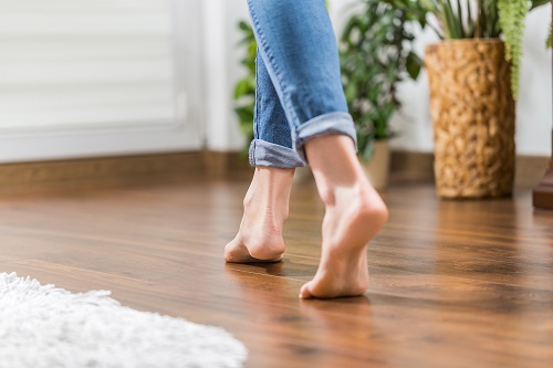 Woman Walking on Hardwood Floor